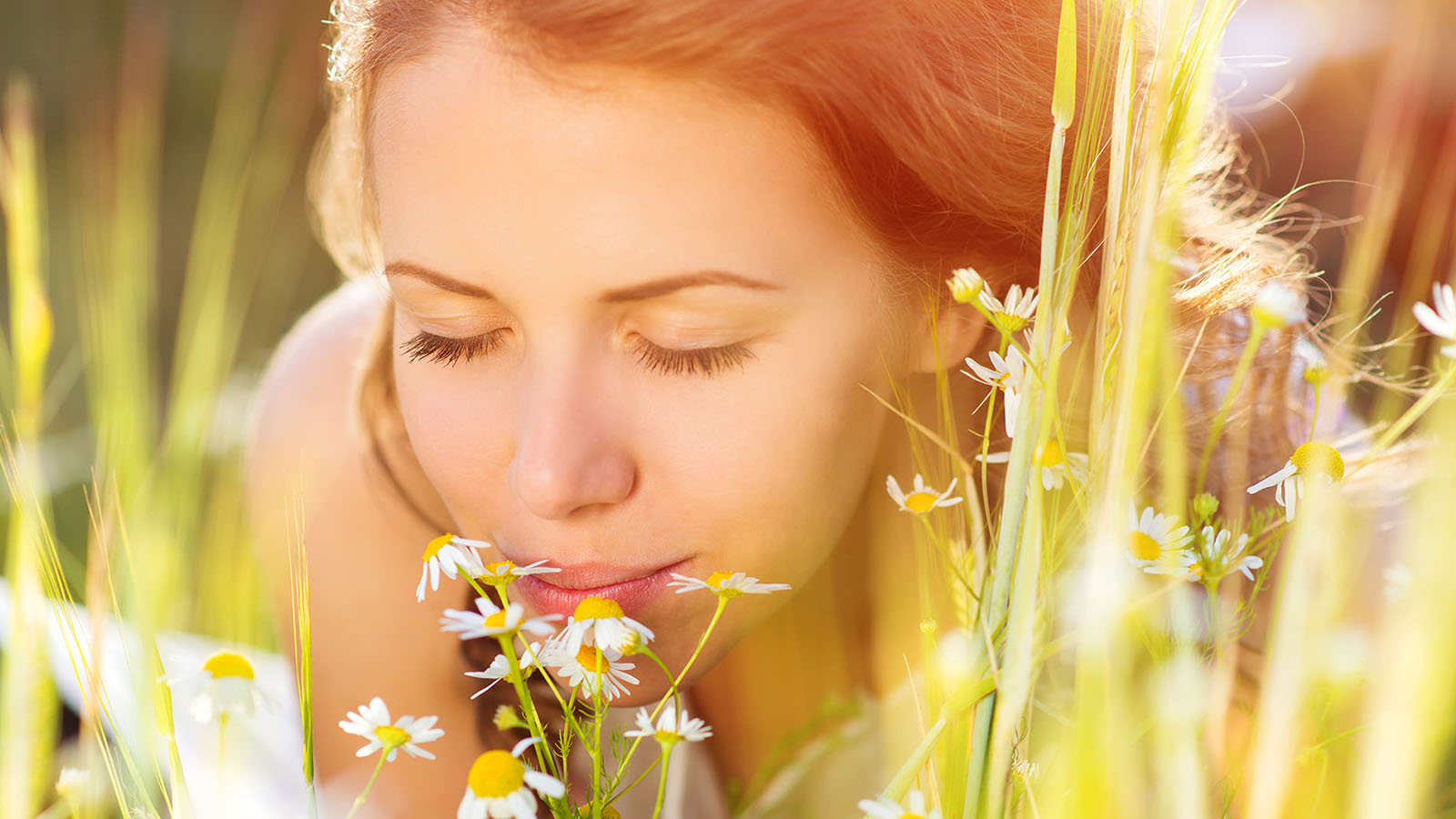 Woman smelling flowers.
