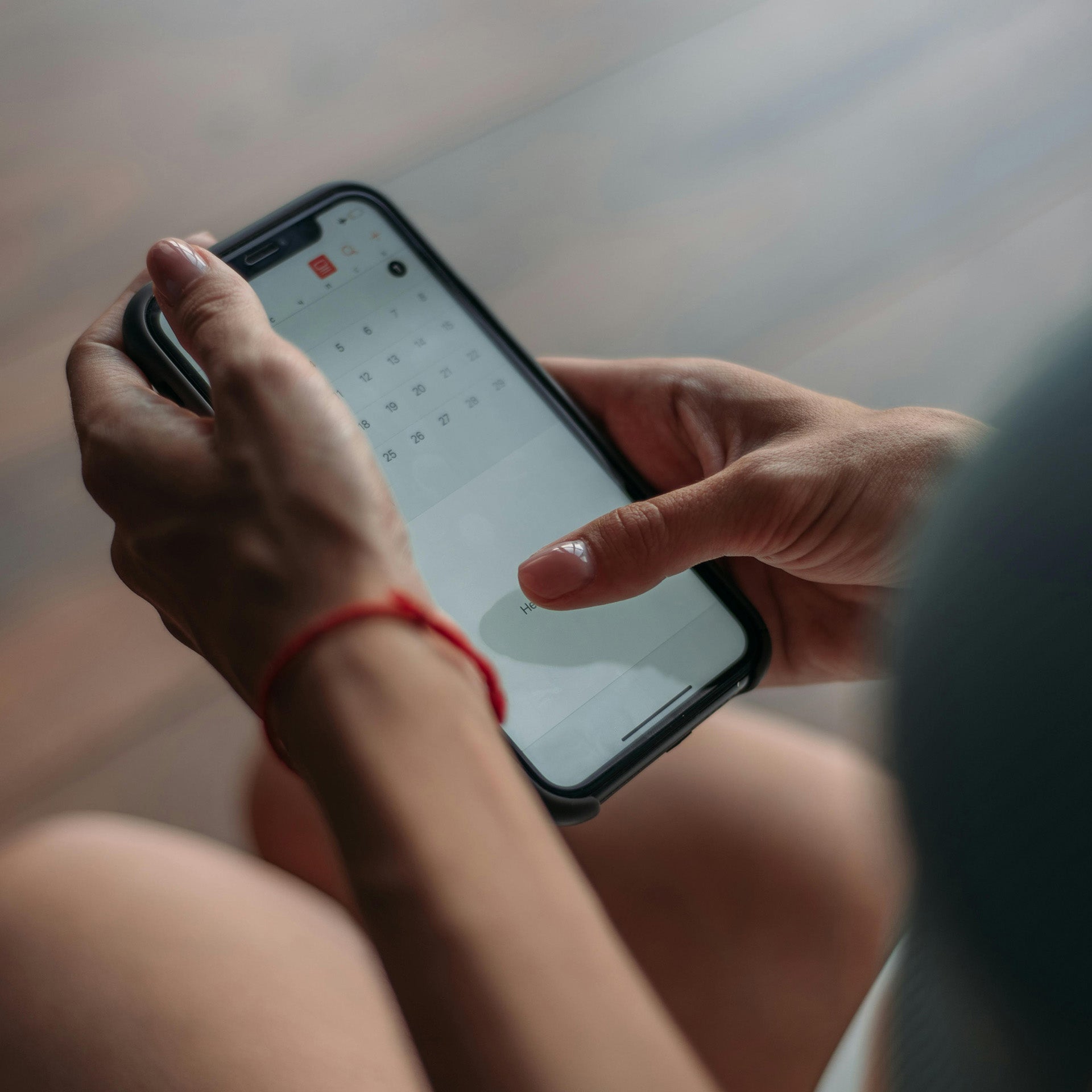 Person using a smartphone with a blurred background